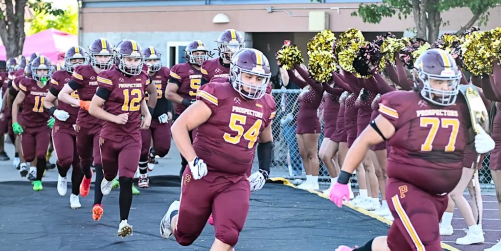 Santa Rosa's Piner High School football team runs onto the field.