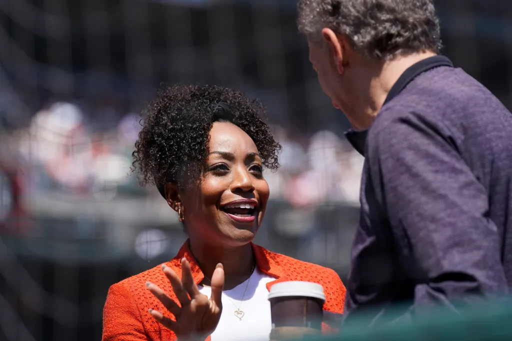 California State Controller Malia Cohen talks with San Francisco Giants owner and CEO Larry Baer.