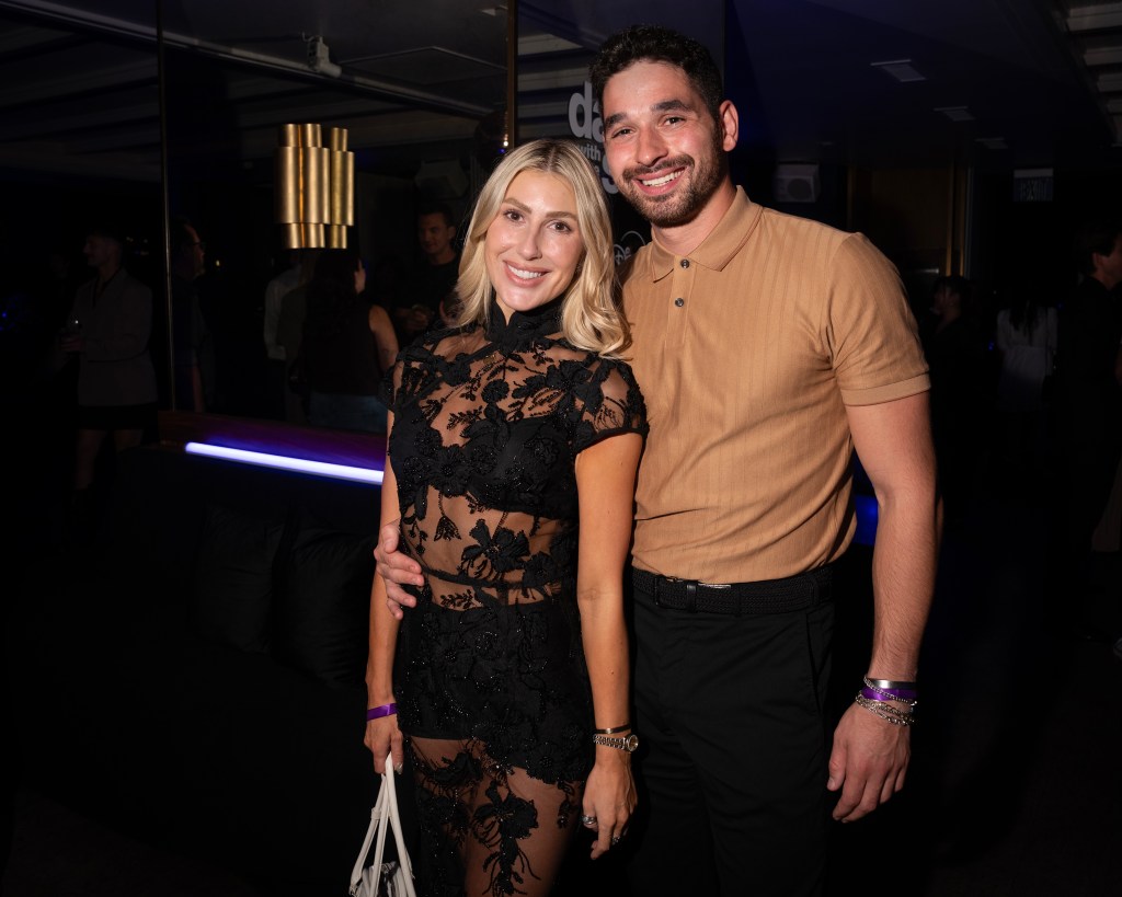 Emma Slater and Alan Bersten pose together at a celebration event.