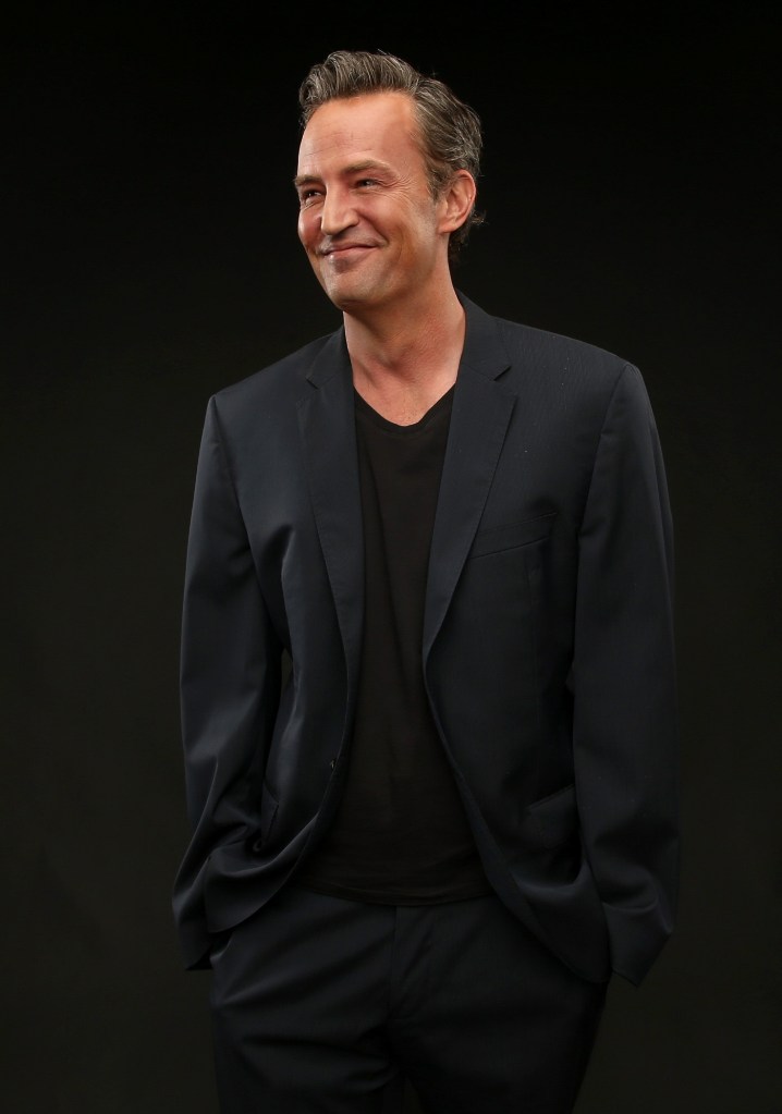 Actor Matthew Perry poses for a portrait against a black background.