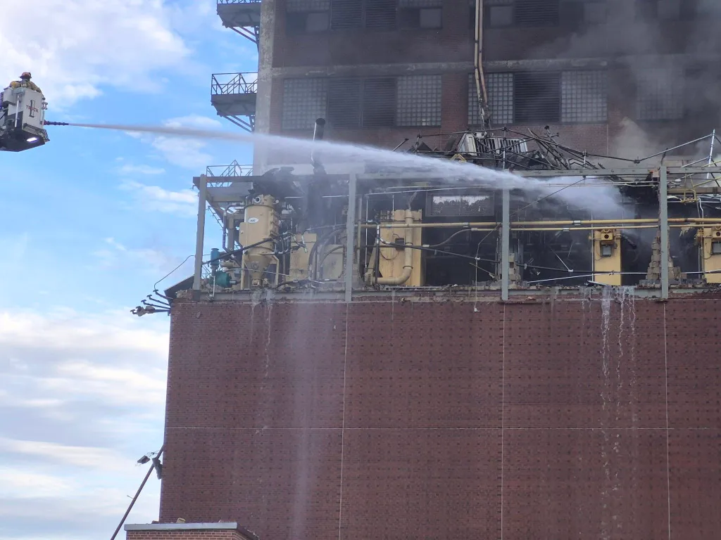 Firefighters spray water on the Quaker Oats plant in Cedar Rapids following an explosion.