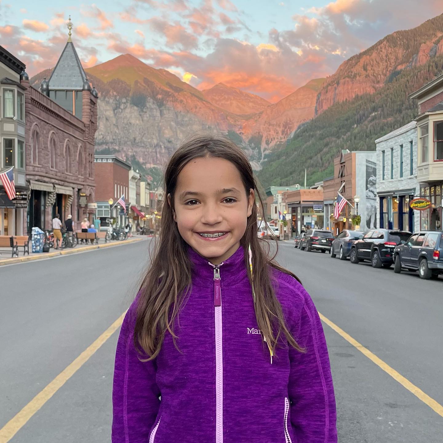 Photo of Chad Lowe's daughter Fiona standing on a town street with mountains in the background.
