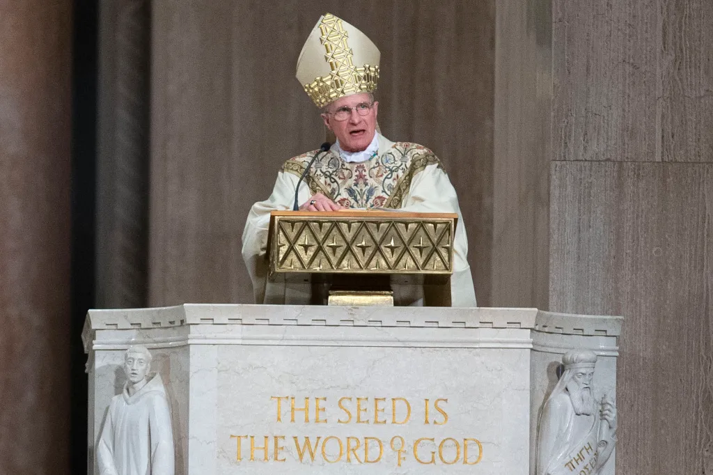 Archbishop Timothy Broglio conducts Mass from a pulpit at the Basilica of the National Shrine of the Immaculate Conception.