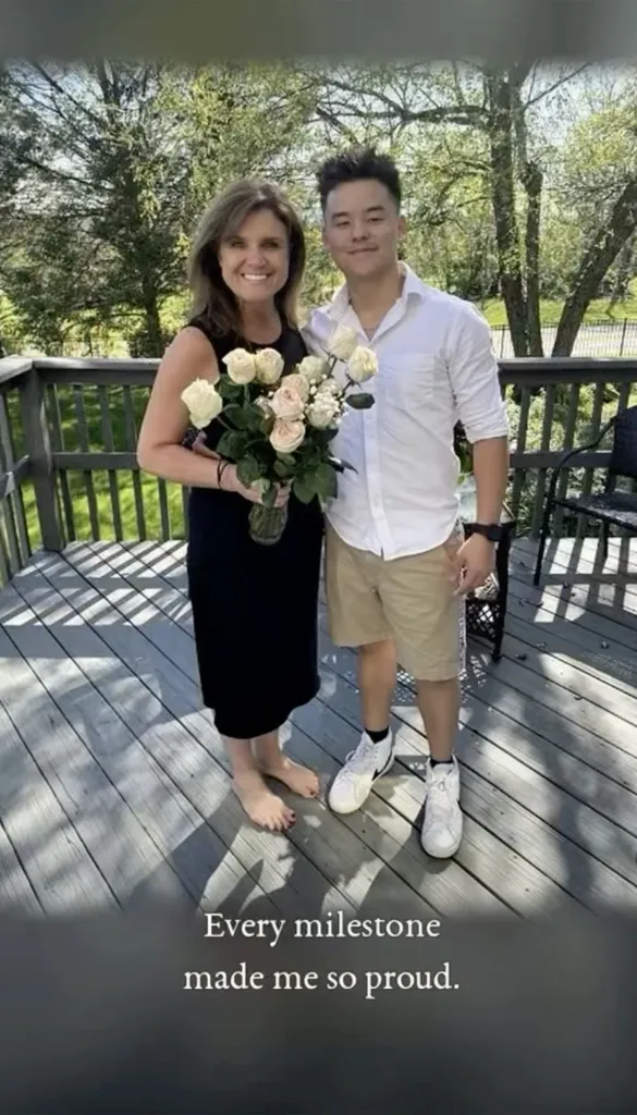 Colleen Conrad and Collin Gosselin stand together on a wooden deck, with Conrad holding a bouquet of white and peach roses.