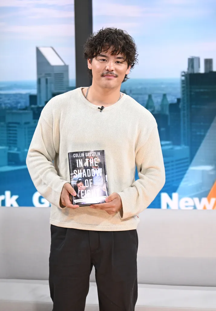 Collin Gosselin holding his new book, 