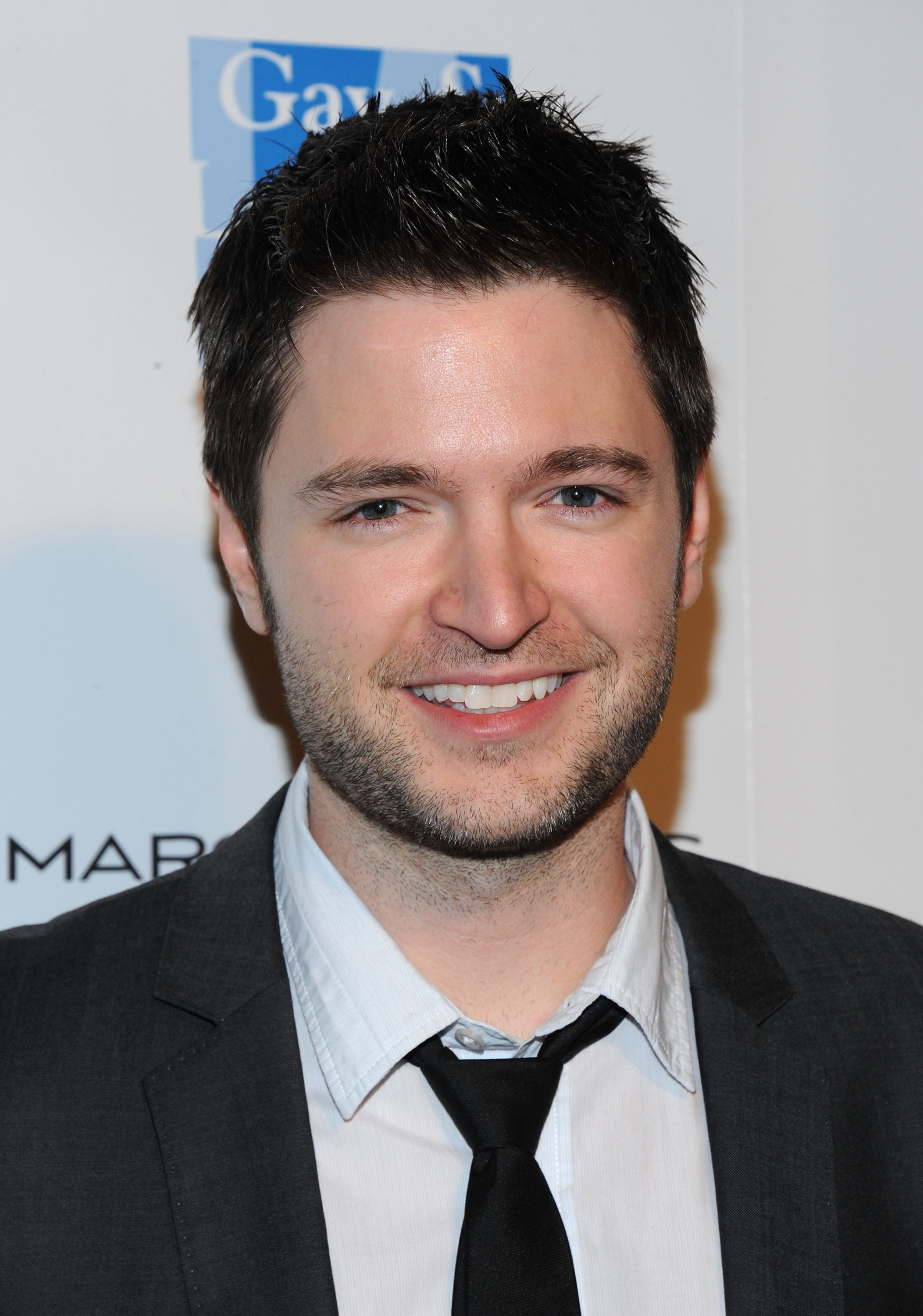 Composer Lucian Piane smiling at an event.