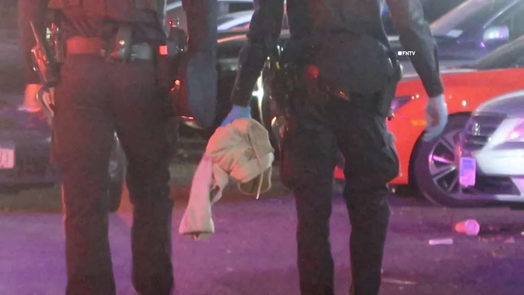 Police investigate the scene of a shooting on Wednesday, Oct. 7, 2026, in Manhattan, New York. A 15-year-old male was killed and a 57-year-old male was injured in the shooting, and a person of interest was taken into custody at the scene.