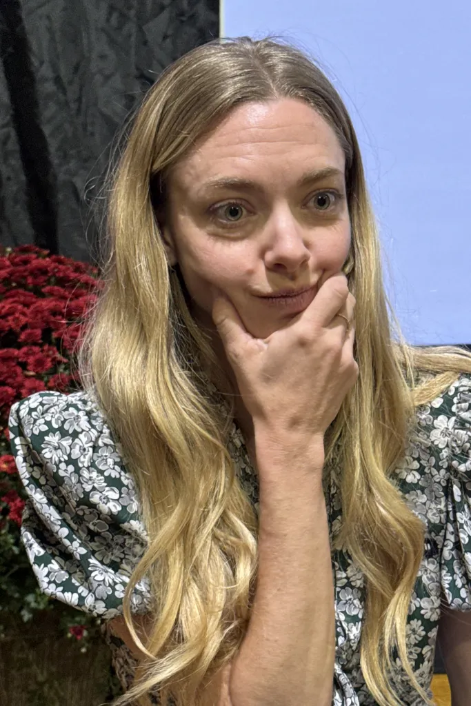 Amanda Seyfried at the Hamptons International Film Festival, resting her chin on her hand.