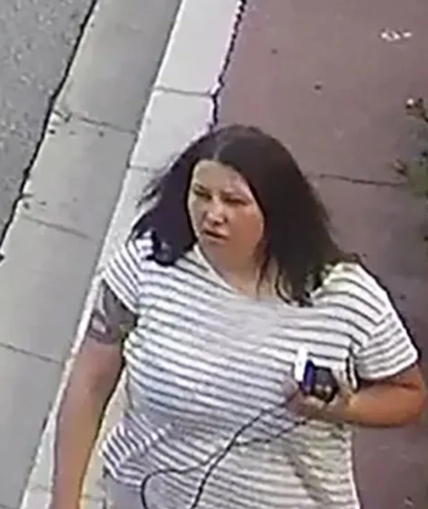 CCTV image of Anastasiia Berezovska walking down a street wearing a striped shirt.