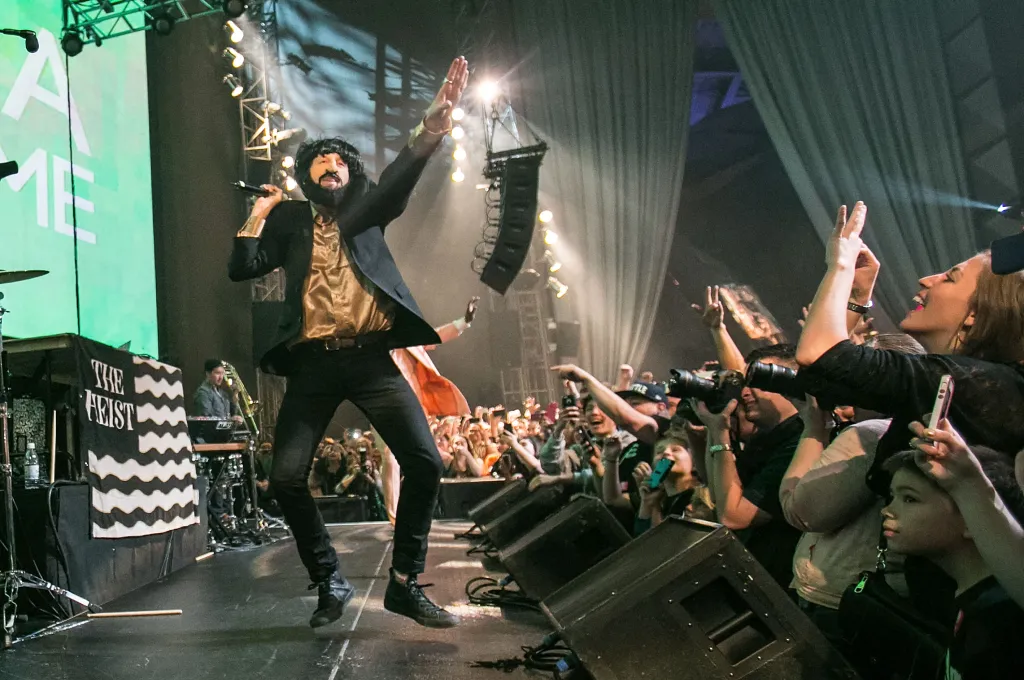 Macklemore performs in costume on stage in front of an enthusiastic crowd.