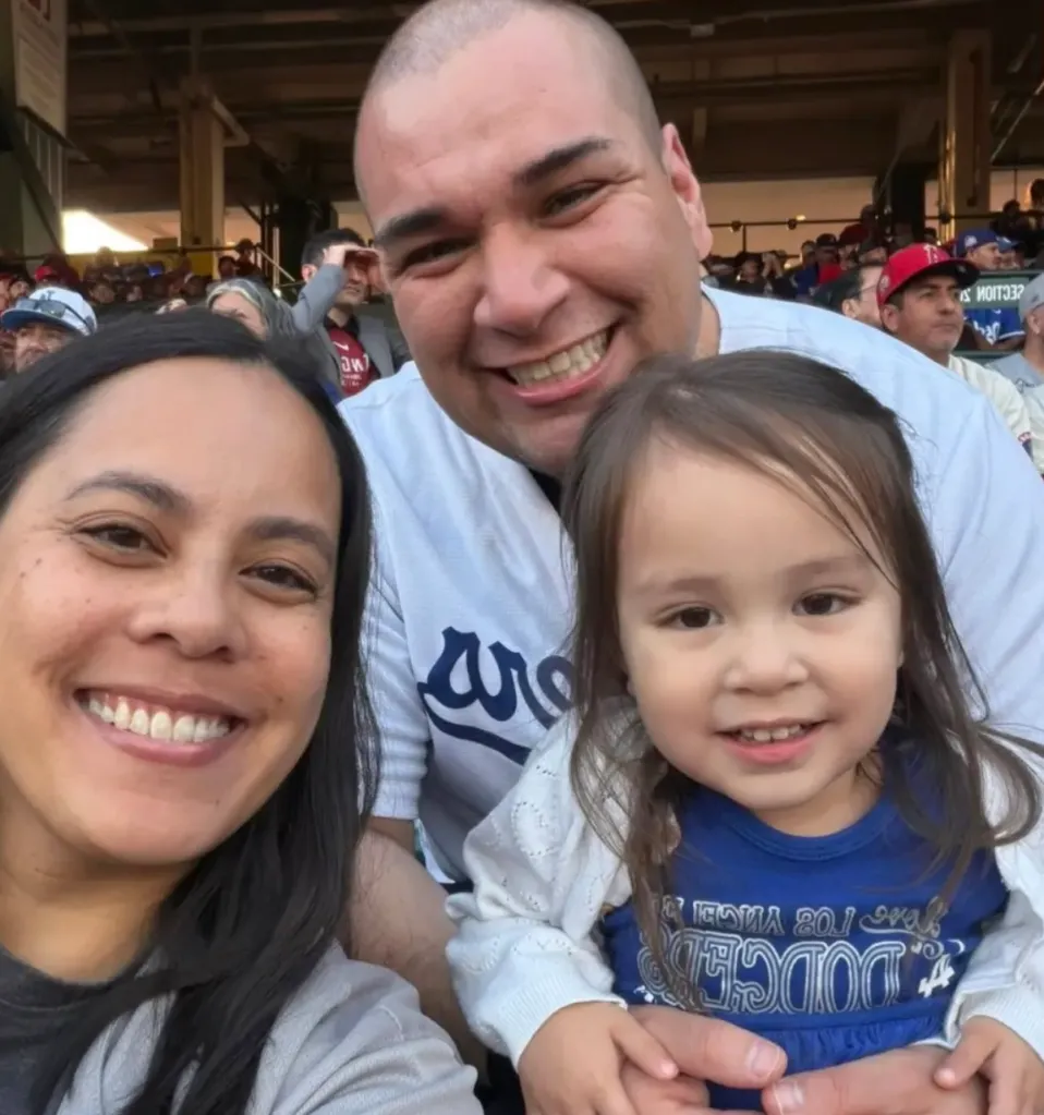 Brianna Nichole, Lt. Col. Gabriel Edstrella, and their daughter Sunny pose together for a photo.
