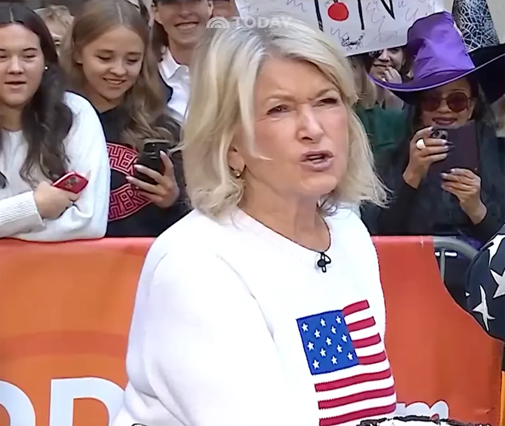 Martha Stewart wearing a white sweater with an American flag patch speaking on the