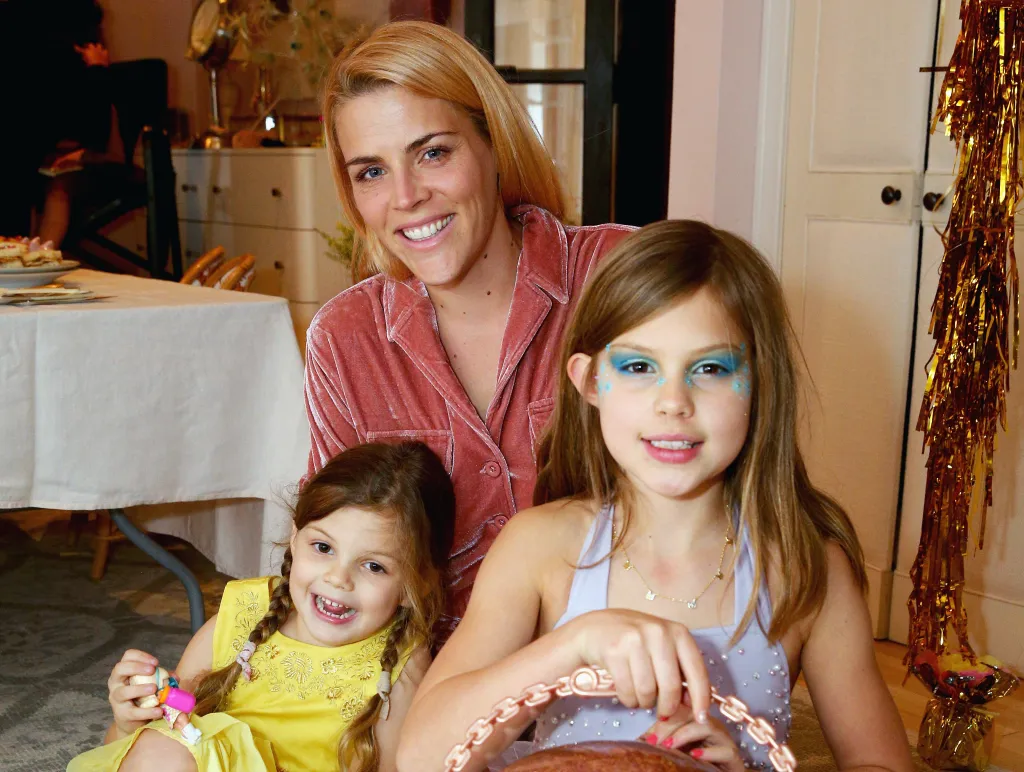 Busy Philipps and her daughters Cricket Pearl Silverstein and Birdie Leigh Silverstein pose together at a party.