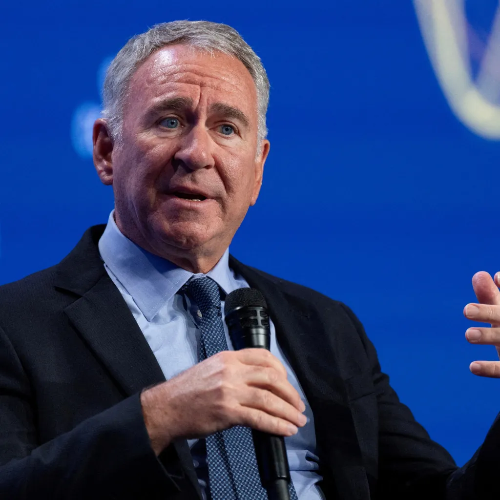 Ken Griffin, founder and CEO of Citadel, speaks into a microphone while gesturing with his hand.