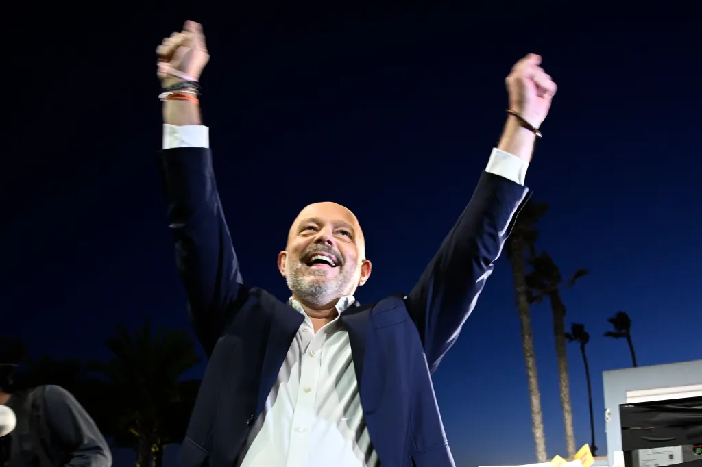 California Republican gubernatorial candidate Steve Hilton raises his arms at a campaign rally in Oceanside, Calif.