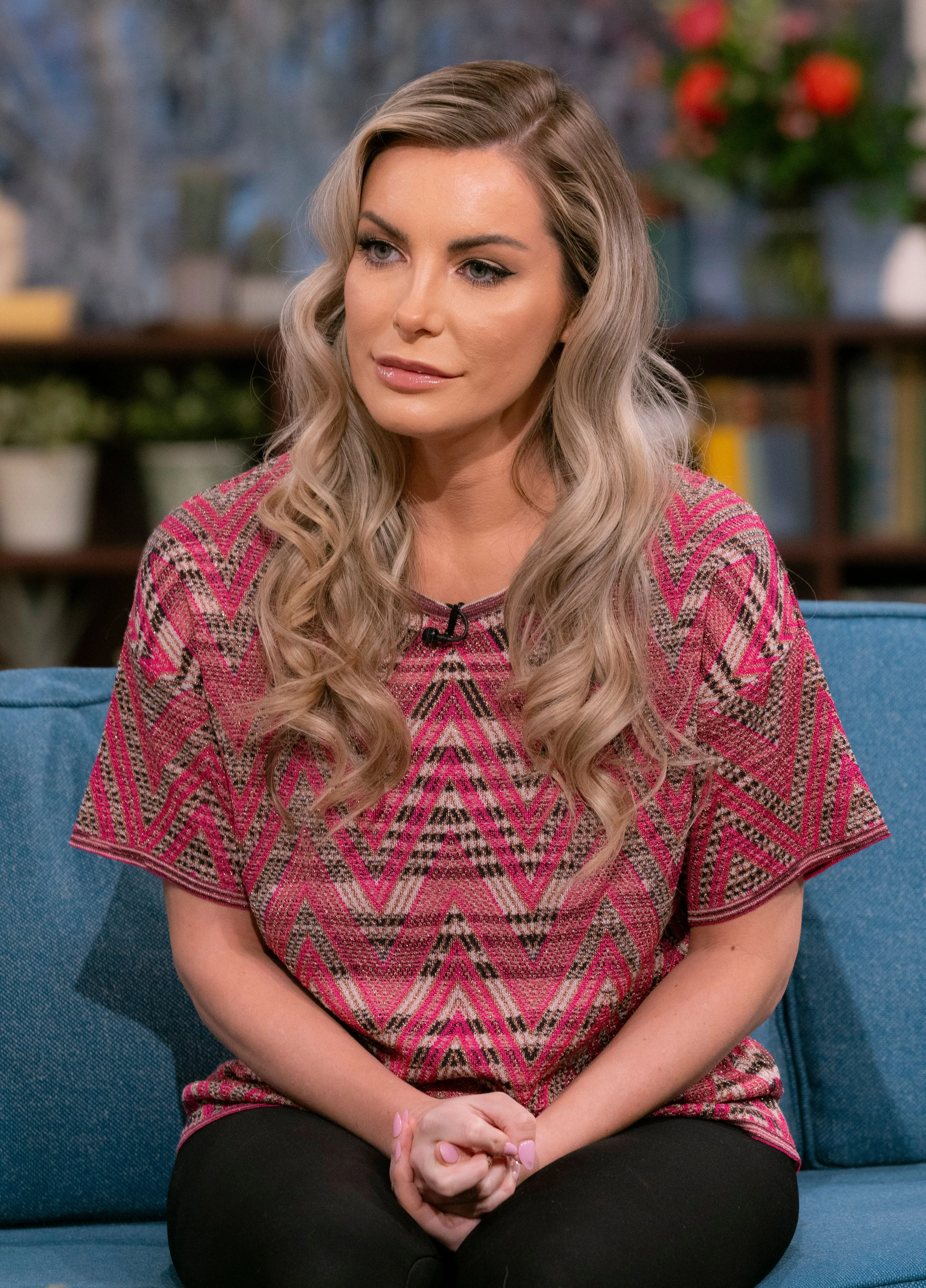 Crystal Hefner sitting on a blue sofa on the set of 'This Morning'.