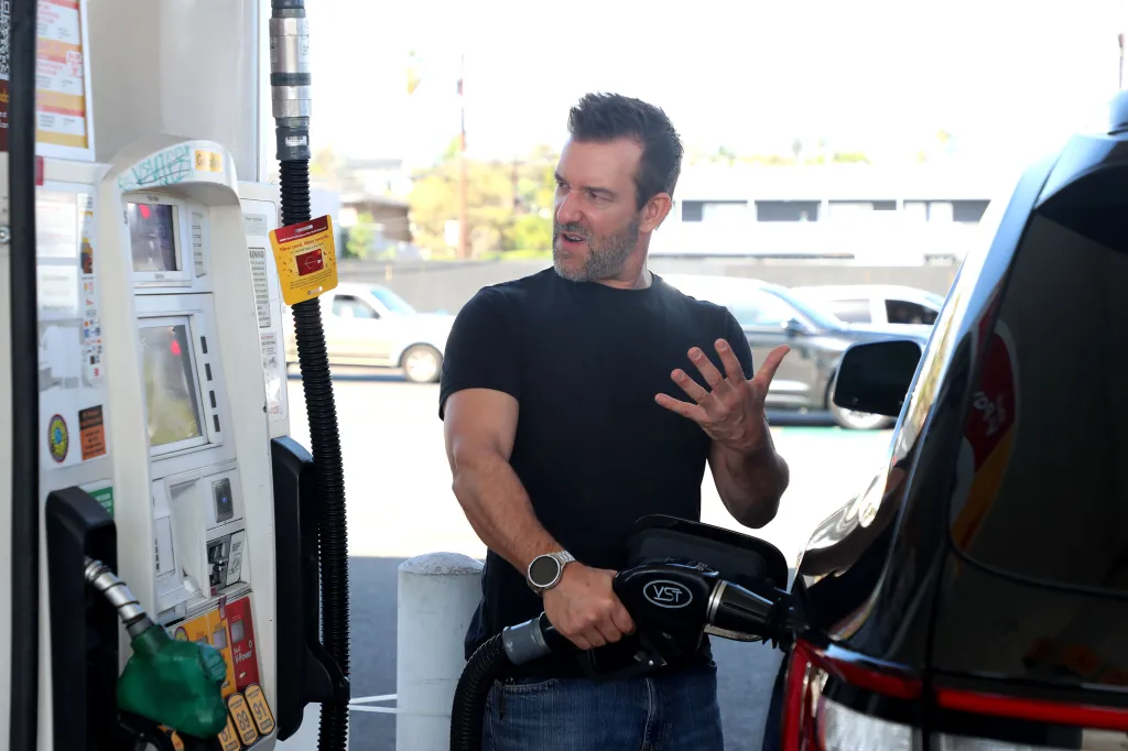 Csaba Mester pumps gas at a Shell gas station.
