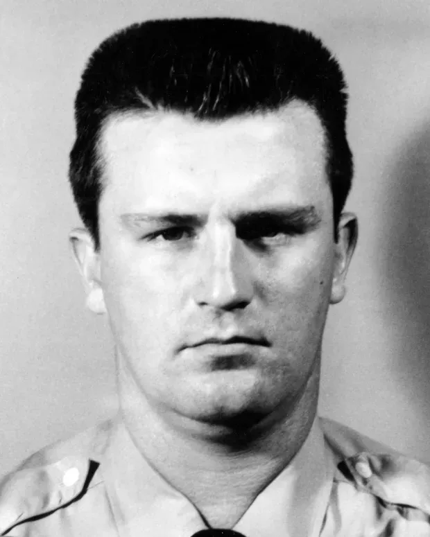 Black-and-white portrait of McInerney in a uniform with a flat-top haircut.