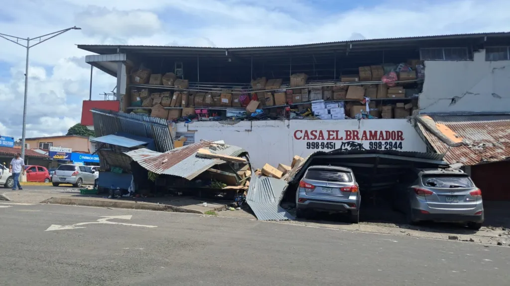 A damaged building with collapsed roofing and exposed storage shelves following an earthquake in Sona, Veraguas Province, Panama.