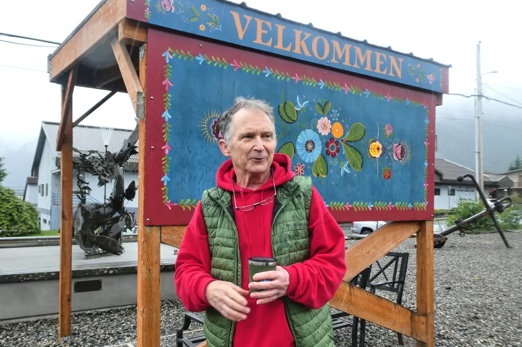 Dan Sullivan stands in front of a welcome sign near downtown Petersburg, Alaska.