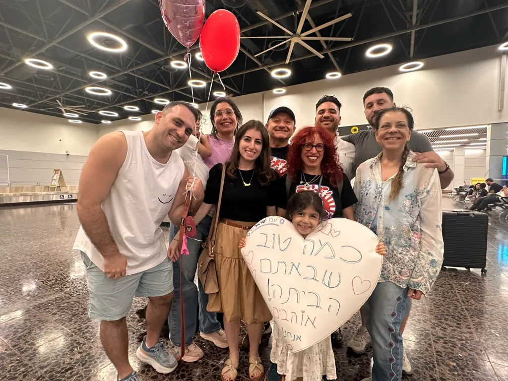Daniel Schlichter and his family pose at Ben Gurion airport.