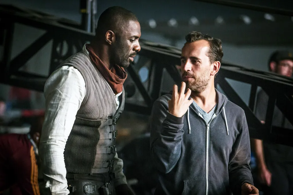 Actor Idris Elba in costume talks with director Nikolaj Arcel on the set of The Dark Tower.