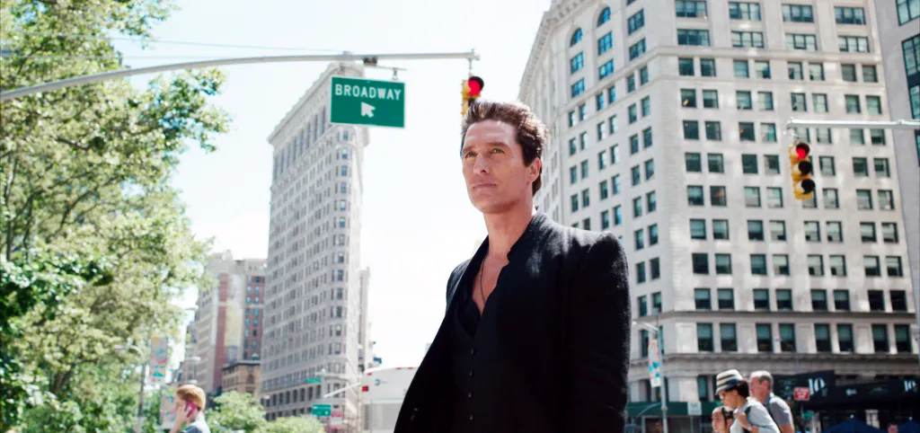 Matthew McConaughey standing on a New York City street near Broadway in a scene from the film The Dark Tower.
