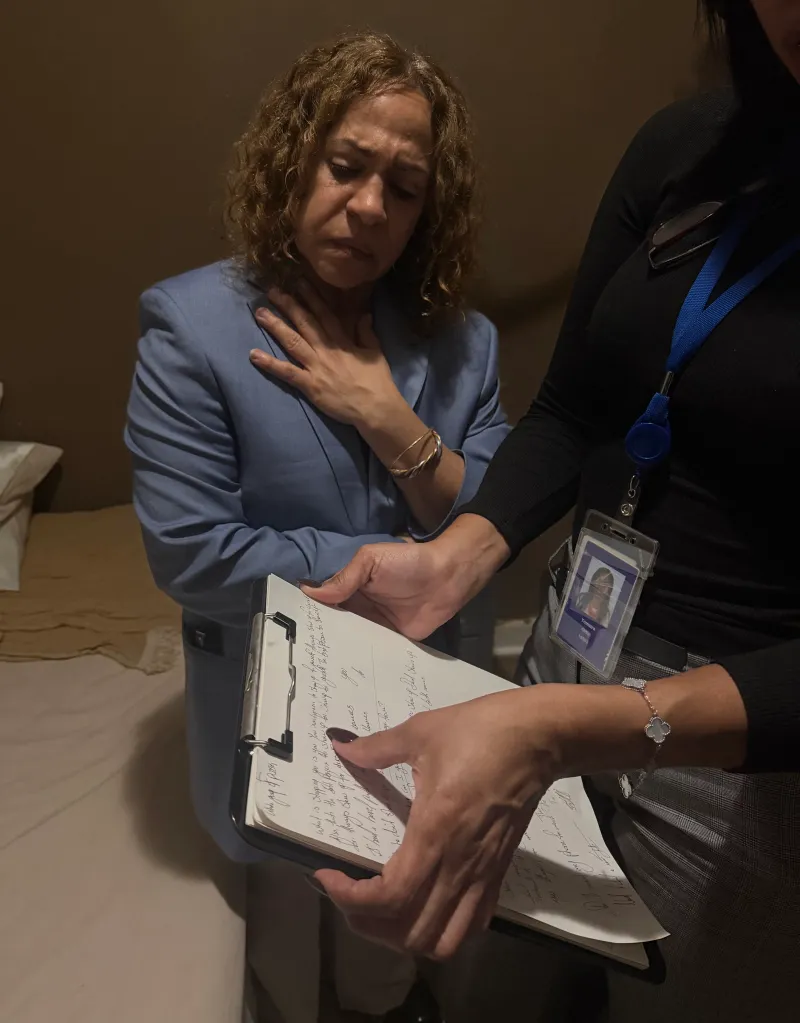 Ana Pichardo looks over at her nephew's handwritten note as a relative translates the thoughts.
