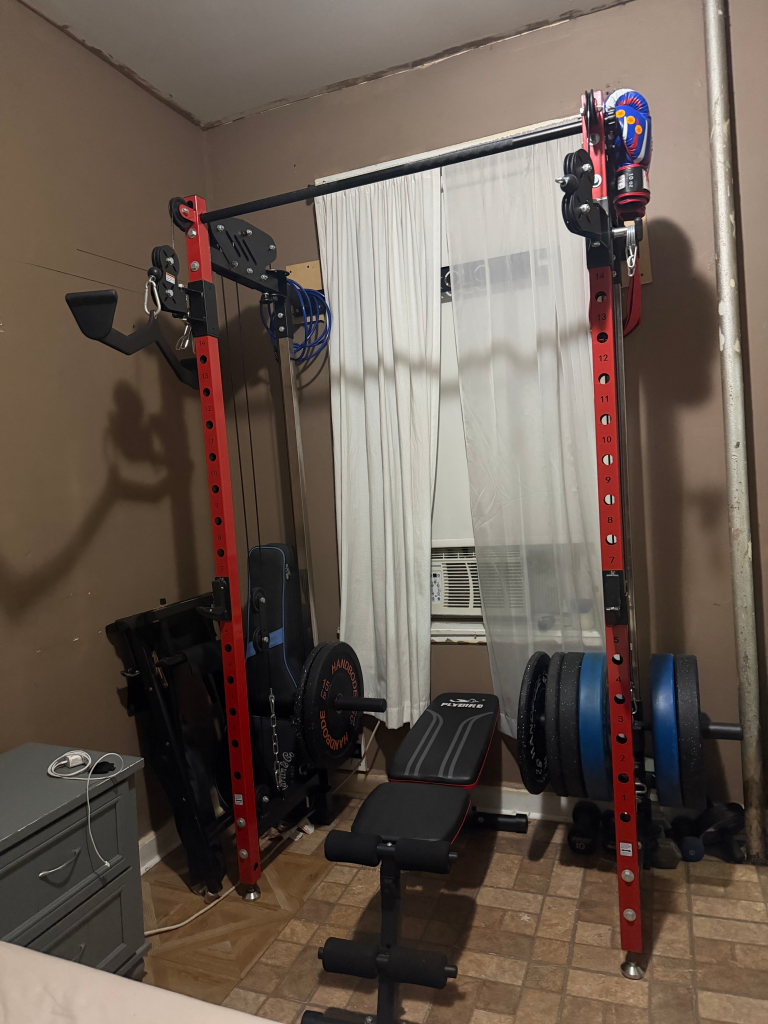 A weight bar and workout bench set up in Darrel Rodriguez's room in the Bronx.