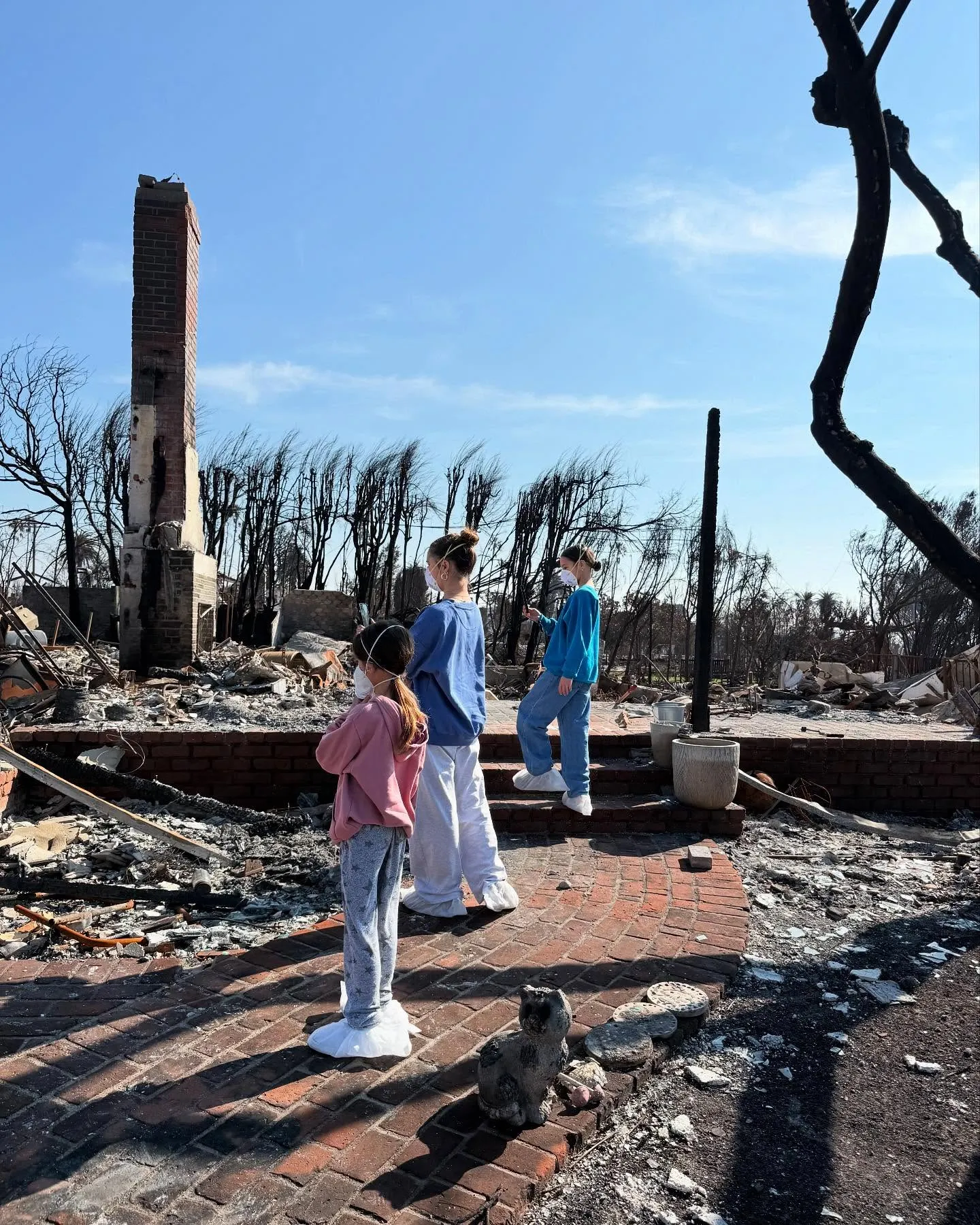 Chad Lowe's daughters, Mabel, Fiona, and Nixie, wearing protective masks amid the aftermath of the Palisades fire.