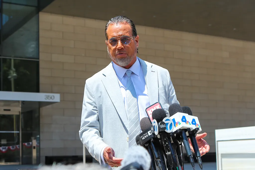 Defense lawyer Steve Haney speaks to reporters outside a courthouse.