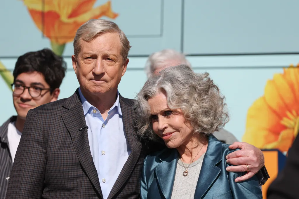 Tom Steyer and Jane Fonda posing together outdoors.