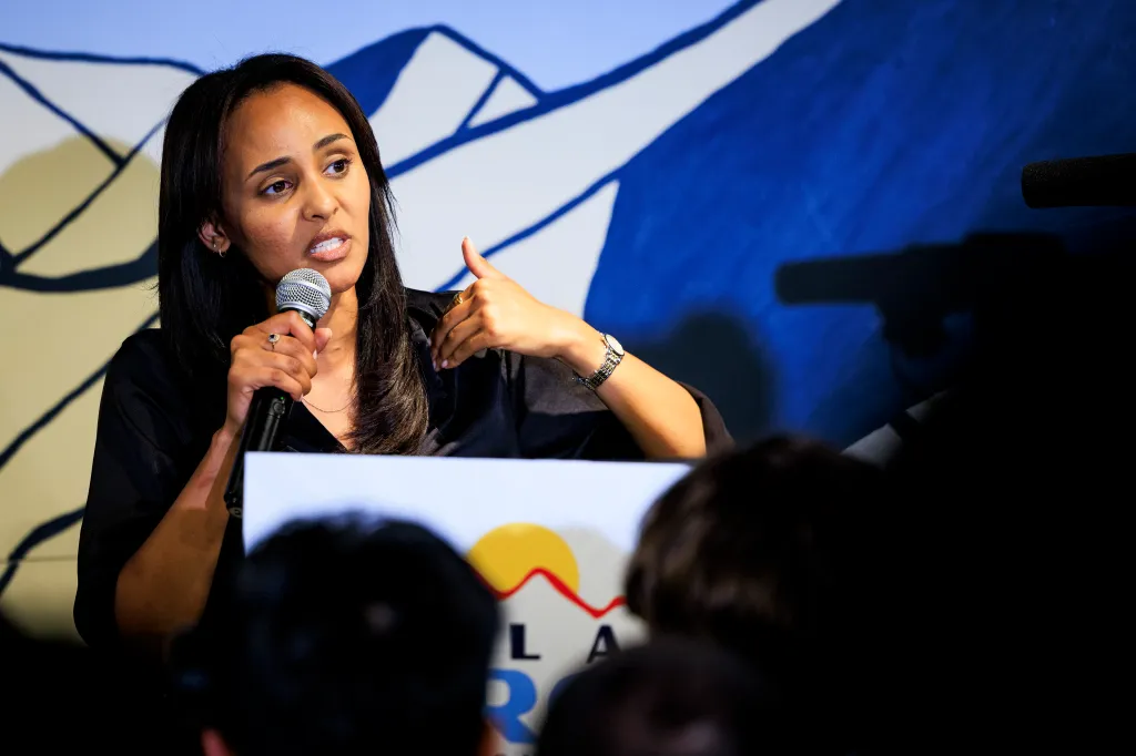 Democratic congressional candidate Melat Kiros speaks into a microphone at a watch party.