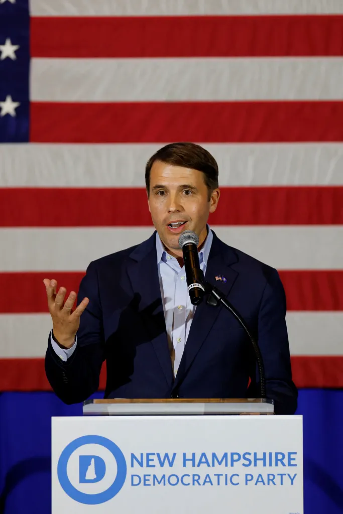 Chris Pappas speaks at a podium in front of an American flag.