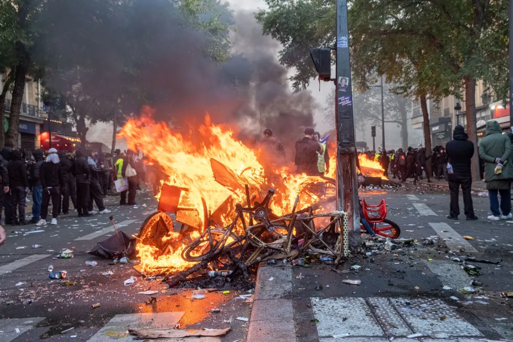 Demonstrators and debris burn in the street during clashes in Paris.