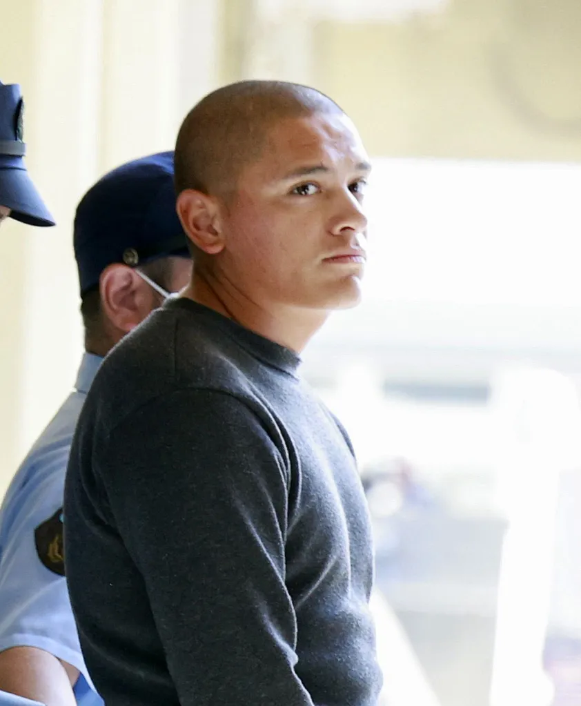 Ballard being escorted to the Naha prosecutors' office in Japan on Monday.