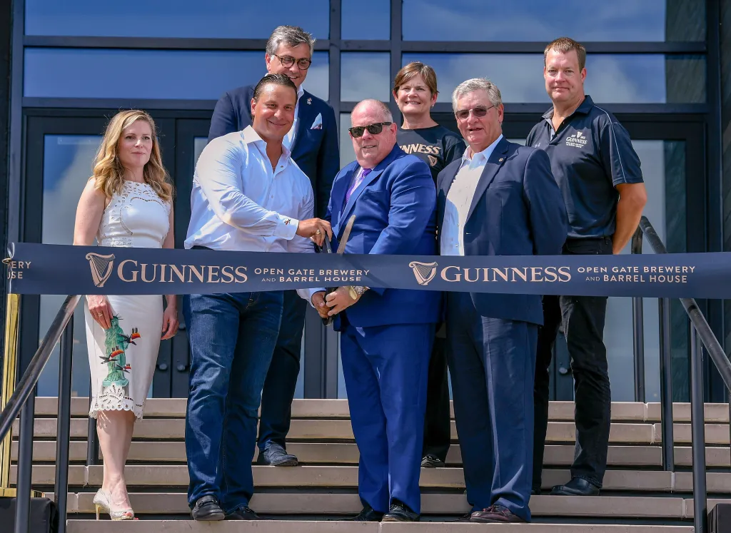 Diageo and Guinness executives cut the ribbon on the Guinness Open Gate Brewery & Barrel House, alongside local government officials.