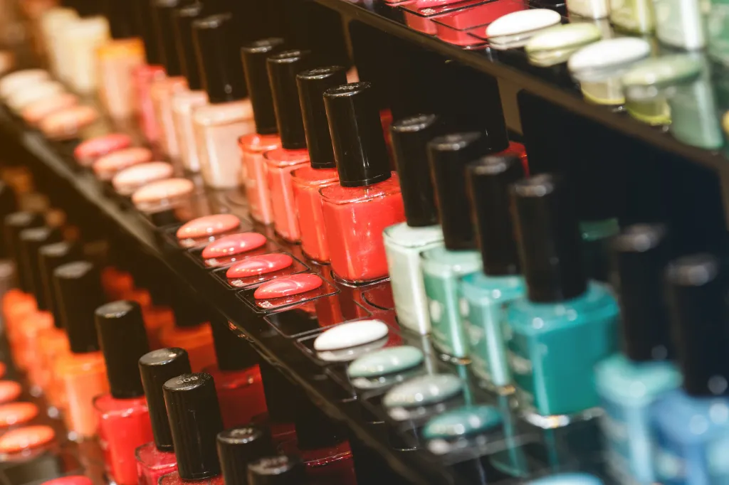 Shelves displaying a large variety of colorful nail polish bottles.