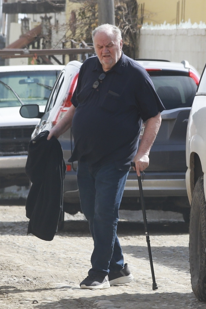 Thomas Markle steps outside his residence in Rosarito, Mexico, carrying a walking cane and a jacket.