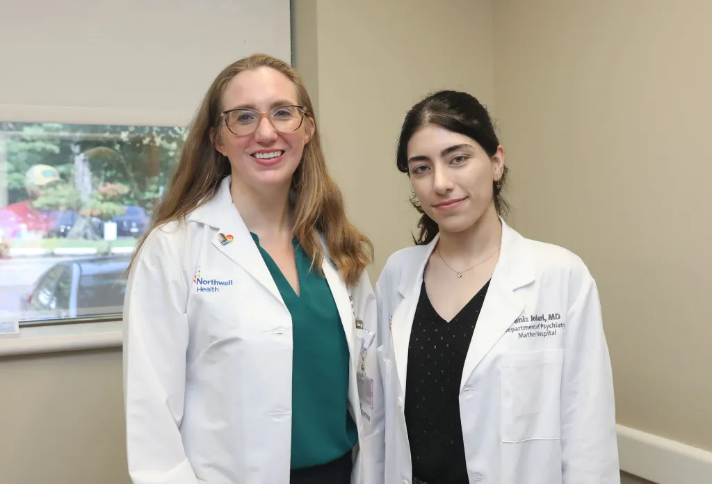 Dr. Erin Dainer and Dr. Paniz Johari standing together in white coats at Mather Hospital.