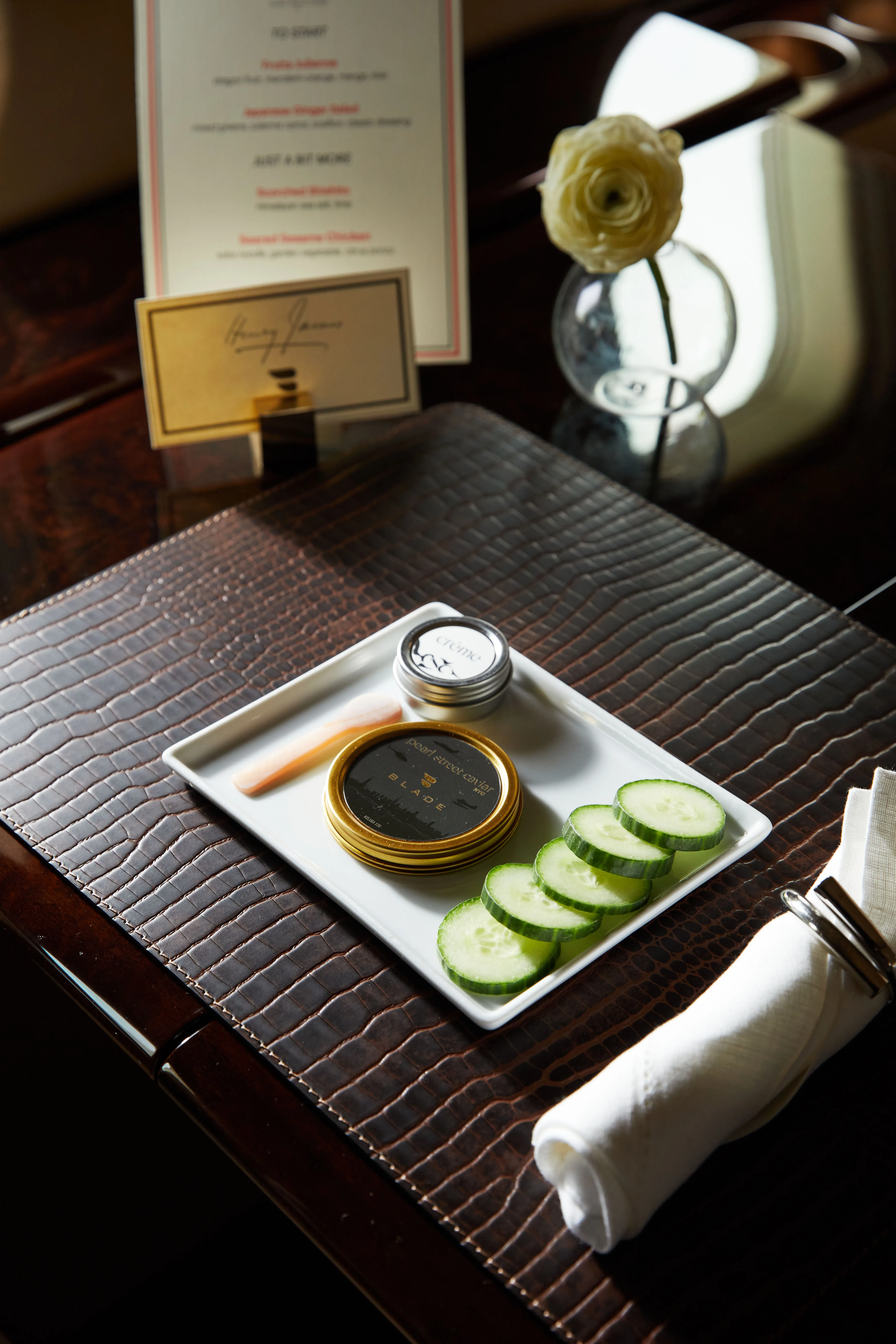 Caviar and cucumber slices served on a white plate aboard the BLADEone jet.