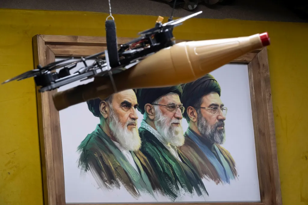 A drone is photographed in front of a poster depicting portraits of Iran's late and new Supreme Leaders, Ayatollah Ruhollah Khomeini, Ayatollah Ali Khamenei, and Ayatollah Mojtaba Khamenei in Tehran on June 5, 2026.