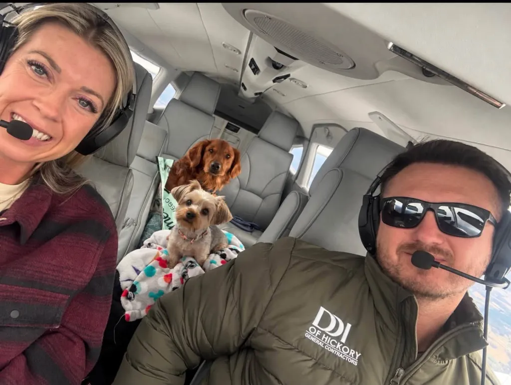 Dustin and Autumn Davis sitting in an airplane with their two dogs.