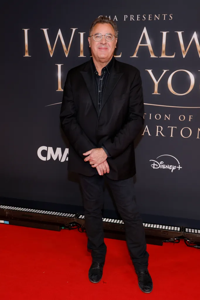 Vince Gill posing on the red carpet at the CMA Presents I Will Always Love You: A Celebration Of Dolly Parton.