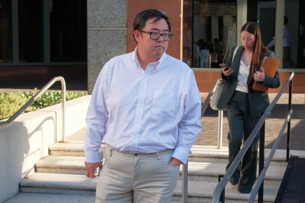 Edric Ding walks outside the federal courthouse in Los Angeles.