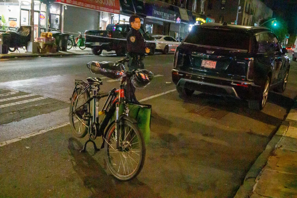 NYPD officers at the scene of an accident involving a car and an electric delivery bike on Nostrand Ave in Brooklyn.