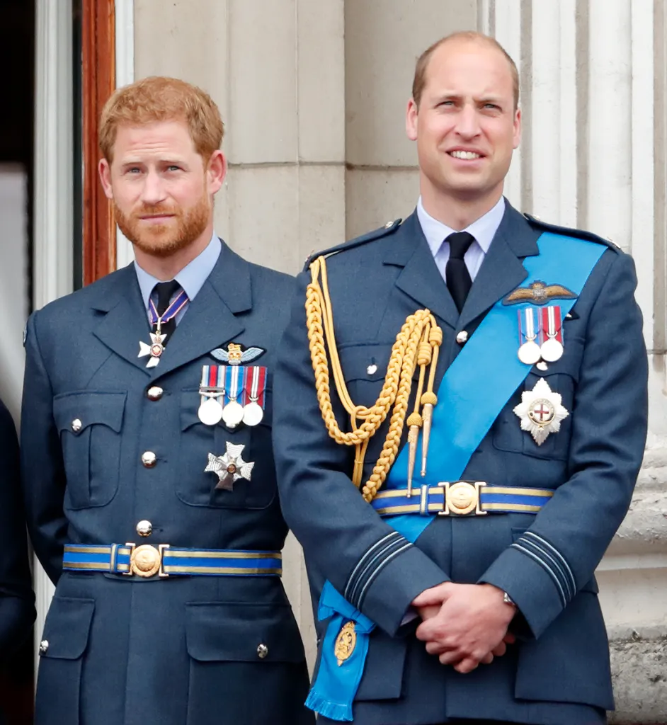 Prince Harry and Prince William in Royal Air Force uniforms on a balcony.