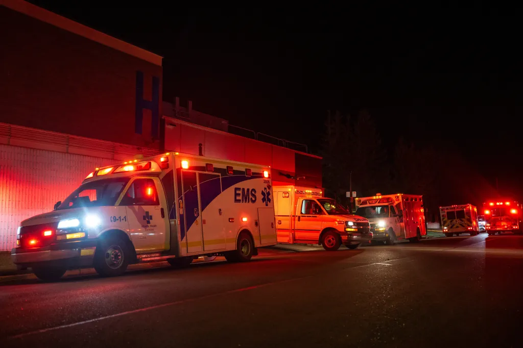 Emergency vehicles parked outside the Wainwright Health Centre at night following a fire at Canadian Forces Base Wainwright.