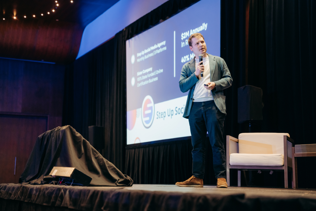 Emil Barr, founder of Flashpass, speaking on stage at an event.