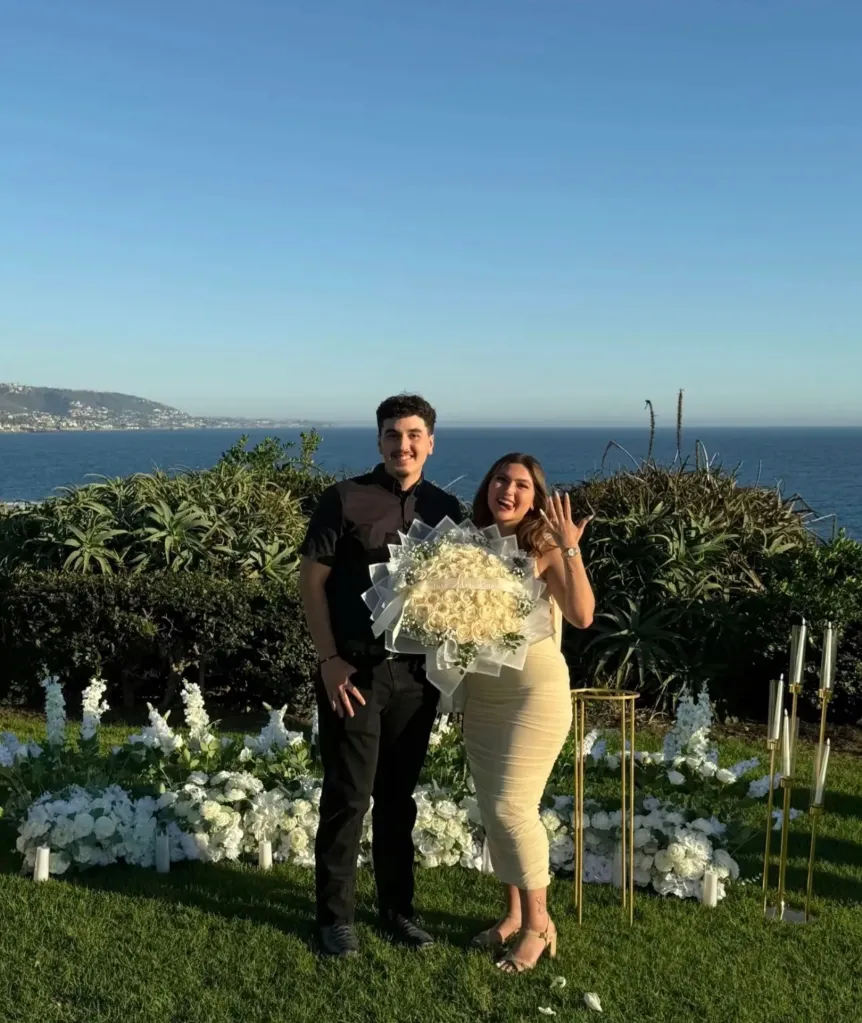 Emmanuel Banuelos and his fiancee, Hayley Lugo, posing outdoors with the ocean in the background.